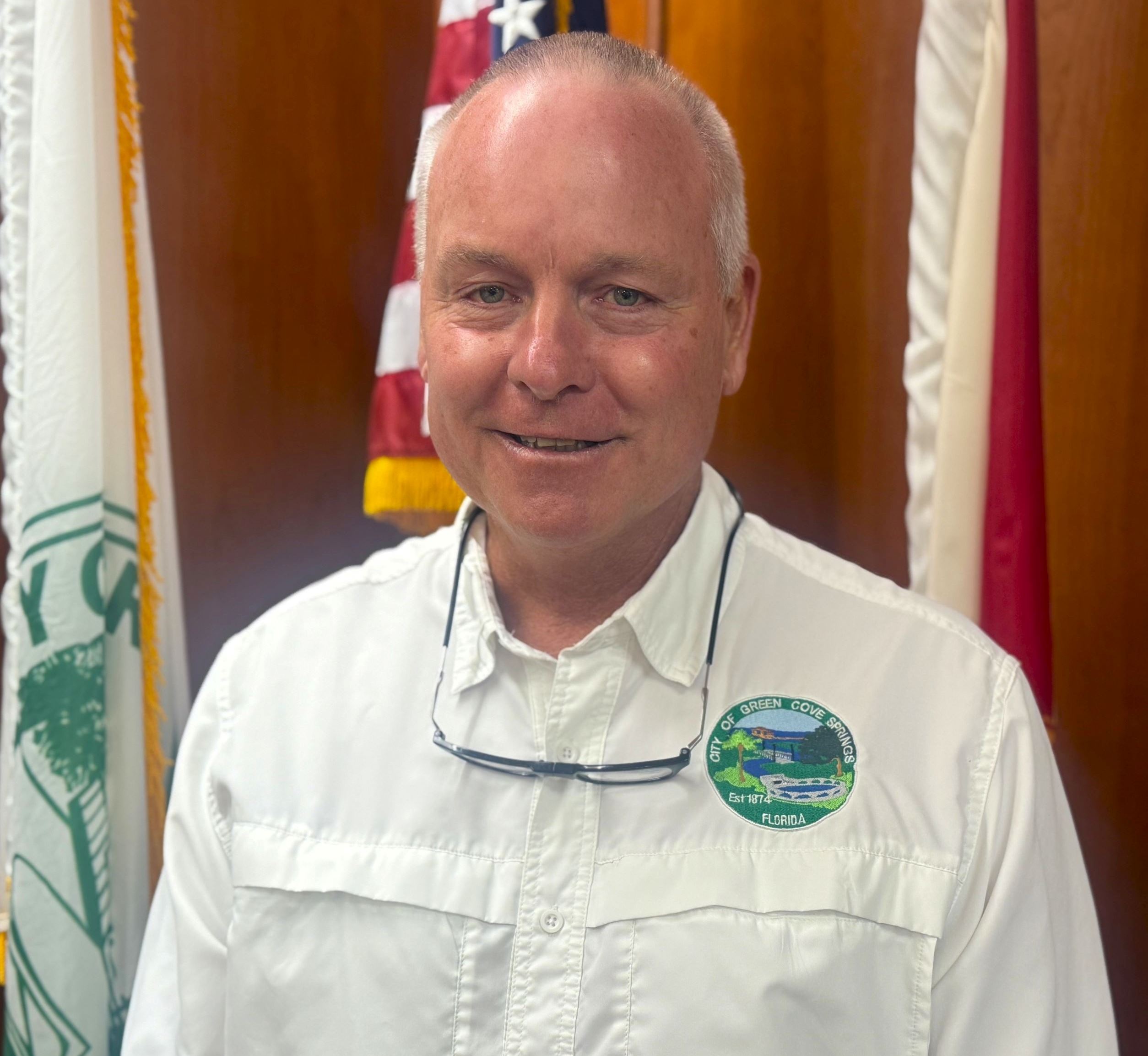 Council Member Gaw standing in front of American Flag in Council Chambers.