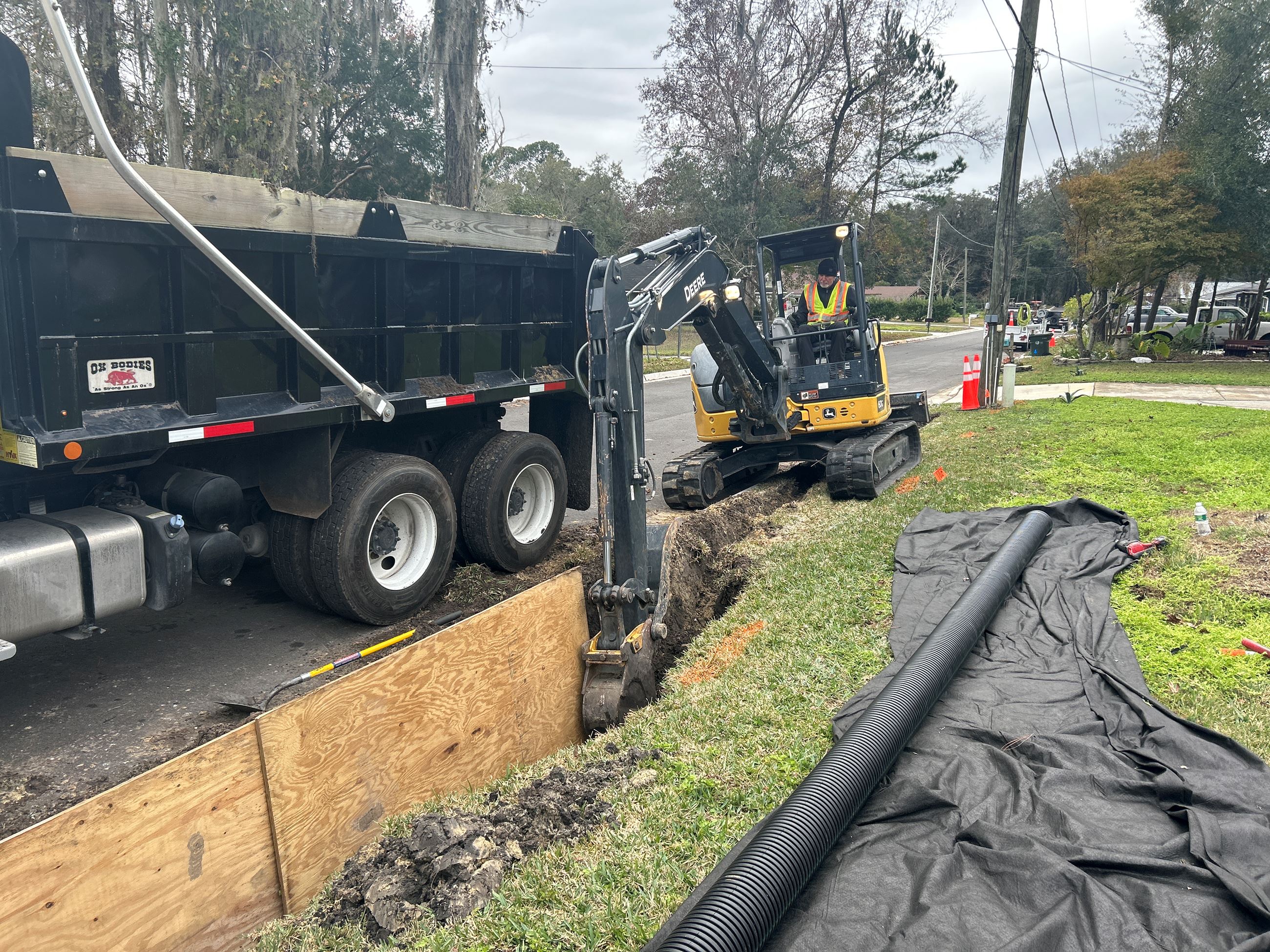 Heavy machinery digging a trench long Julia Street