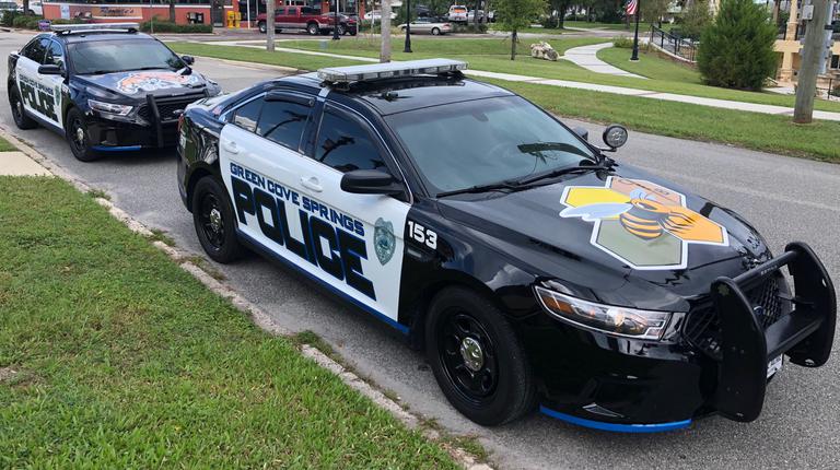 Two Green Cove Springs Police Cars in front of a house