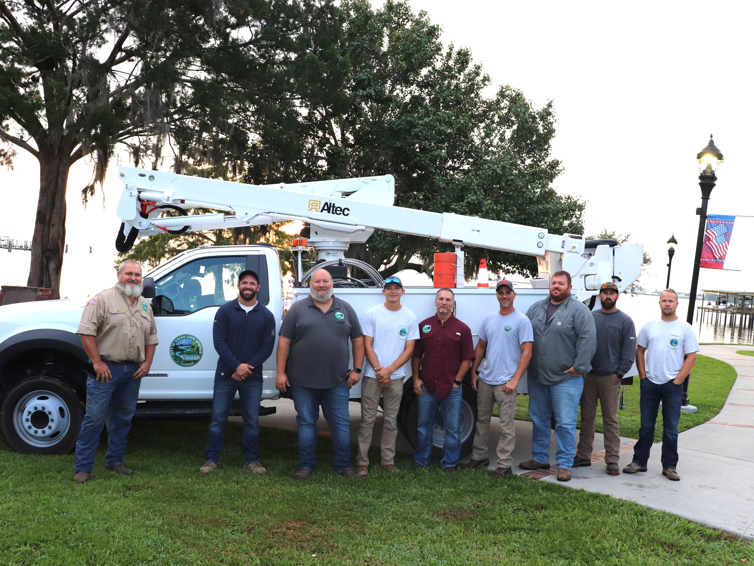 Electric employees standing in front of electric bucket truck in Spring Park